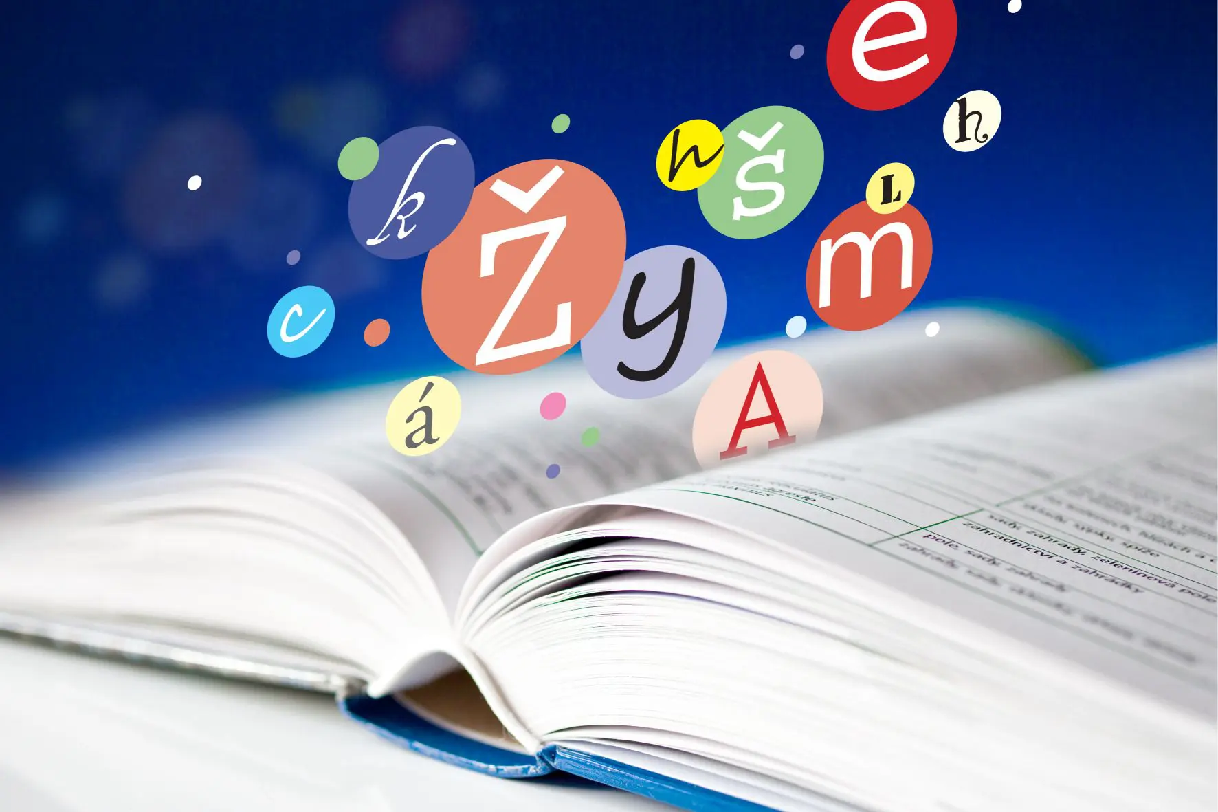 Colorful letters floating above an open book.