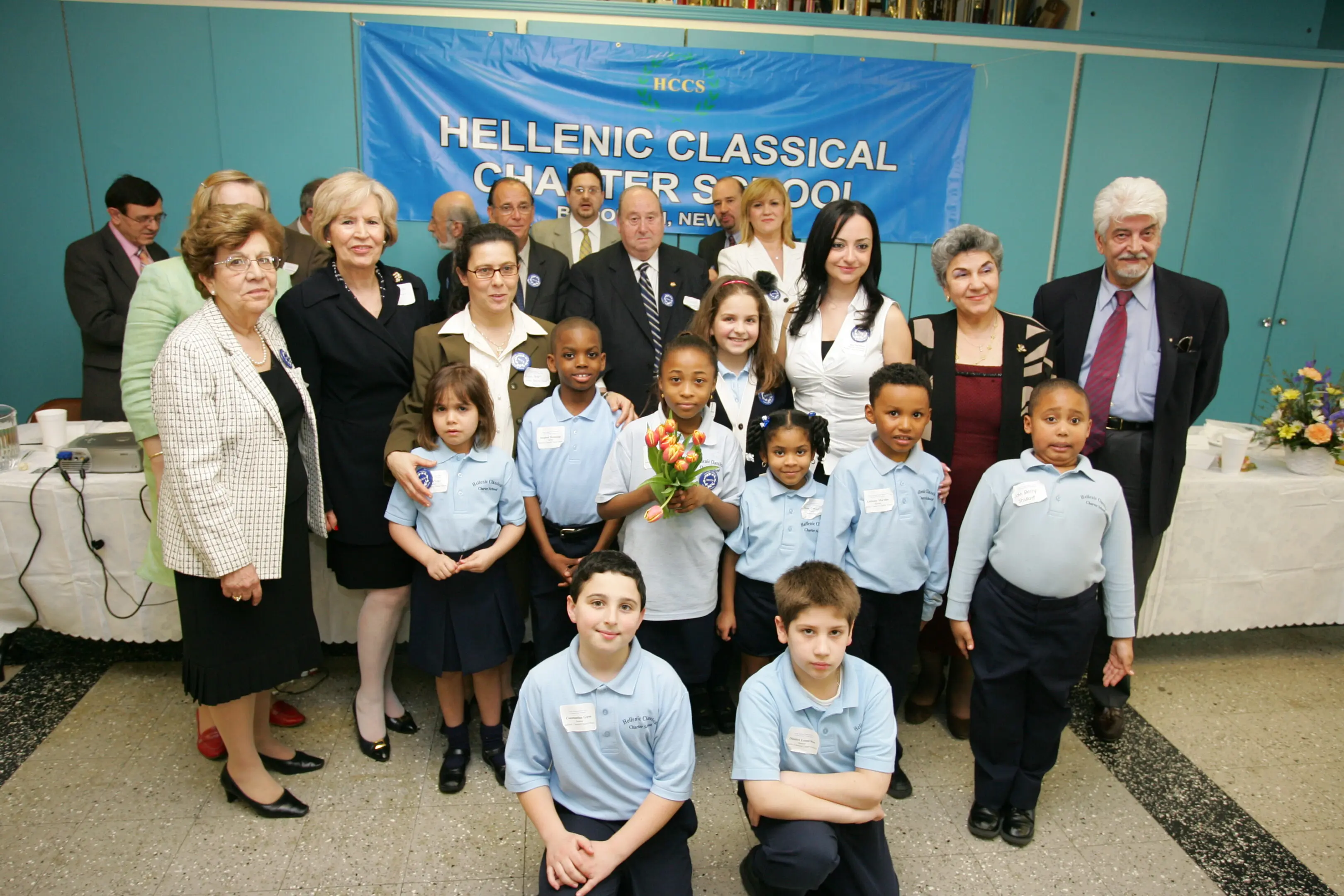 Group photo of children and adults at a classical studies event.