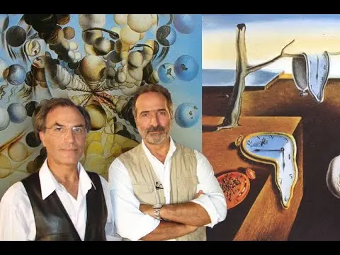 Two men posing in front of surrealist paintings in an art gallery.